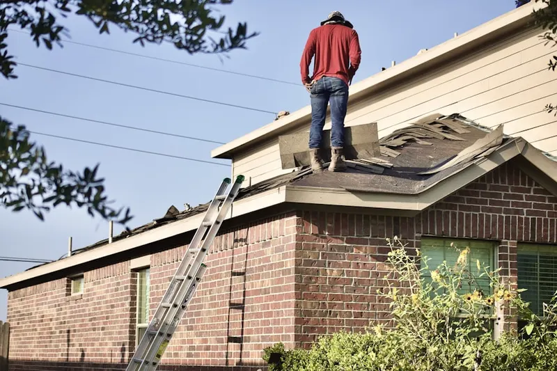 Professional roofer working on a residential roof in West Modesto